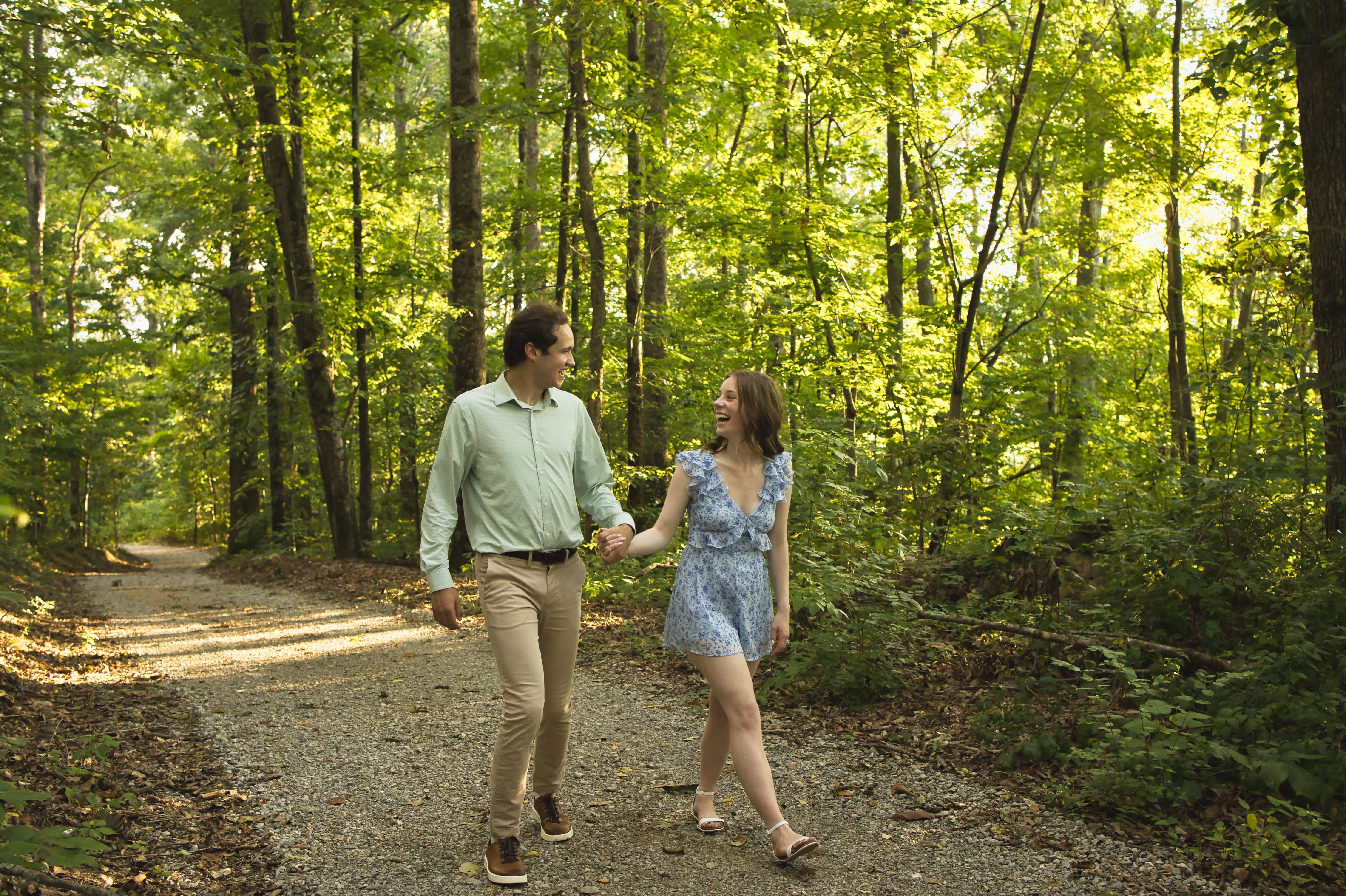 Jess and Josh walking together on a path in the woods
